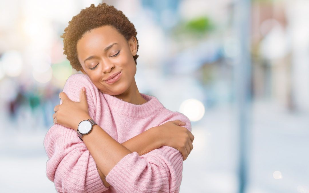 young woman hugging herself. Self love and self care