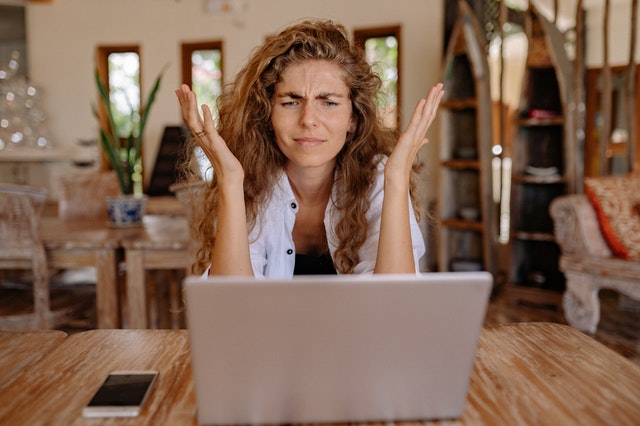 confused woman with her hands up