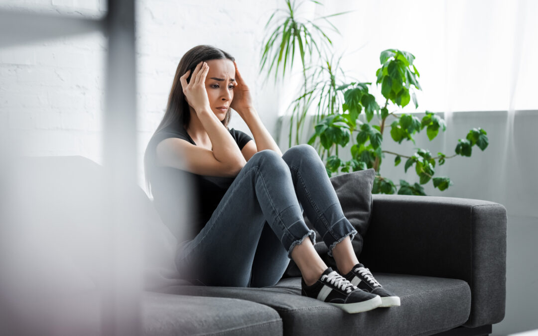 Sad woman sitting on a couch